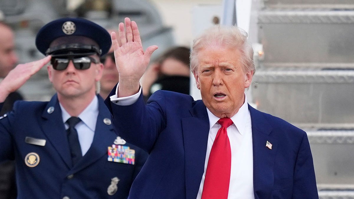 Donald Trump in Miami waving, Air Force officer salutes behind him