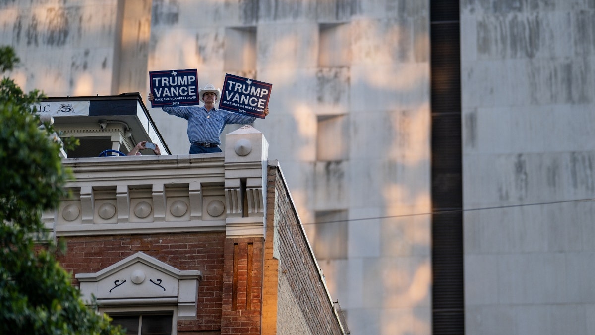 A person displays signs during an "ICE Out of Austin" demonstration on June 09, 2025 in Austin, Texas.