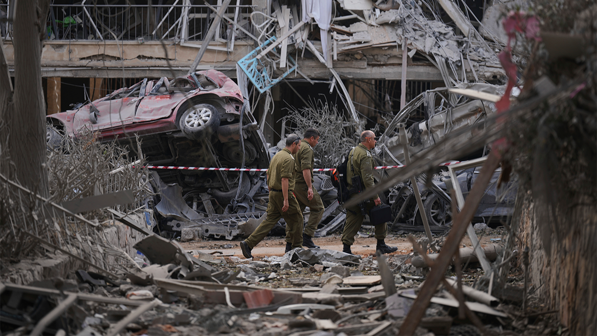 Israeli security forces inspect destroyed residential buildings