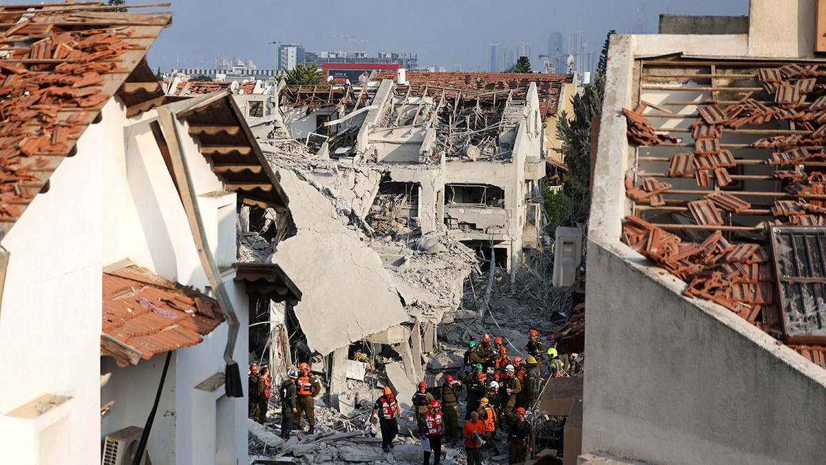 Rescue workers in the middle of a damaged building in Israel