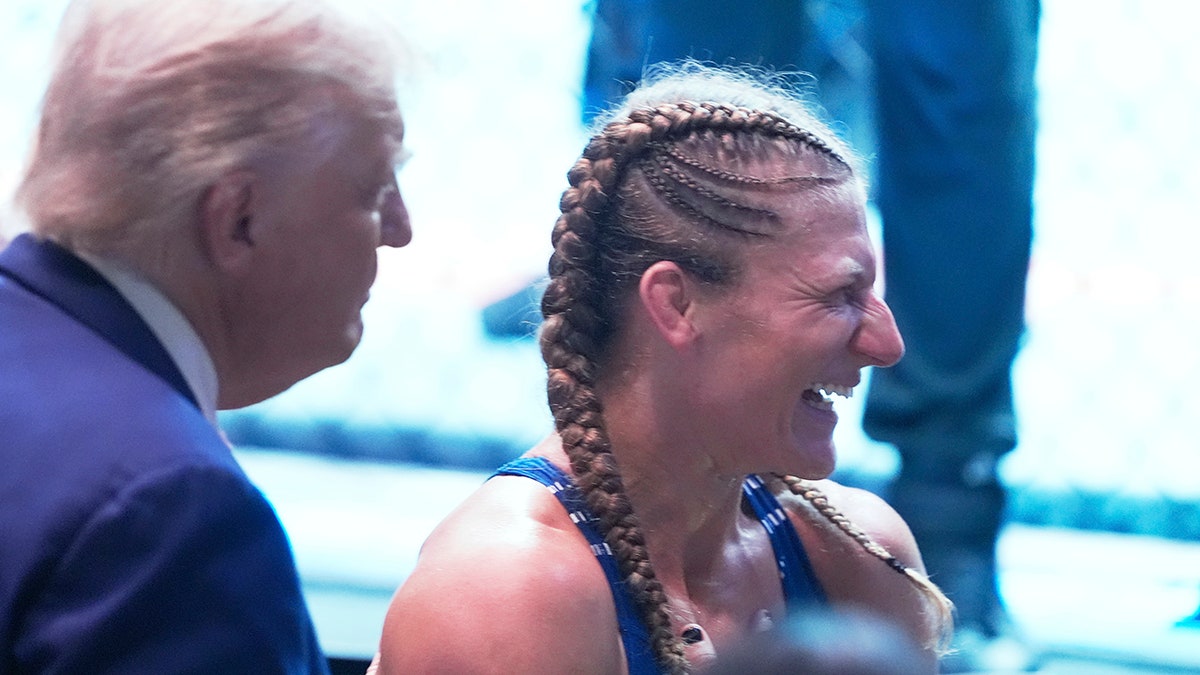 President Donald Trump celebrates with Kayla Harrison