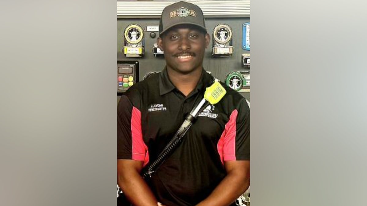 Jay Leons wearing a fire department polo and baseball hat