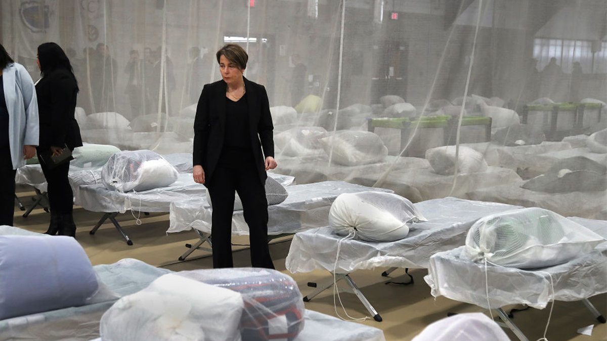 Healey inspecting a migrant shelter's sleeping area