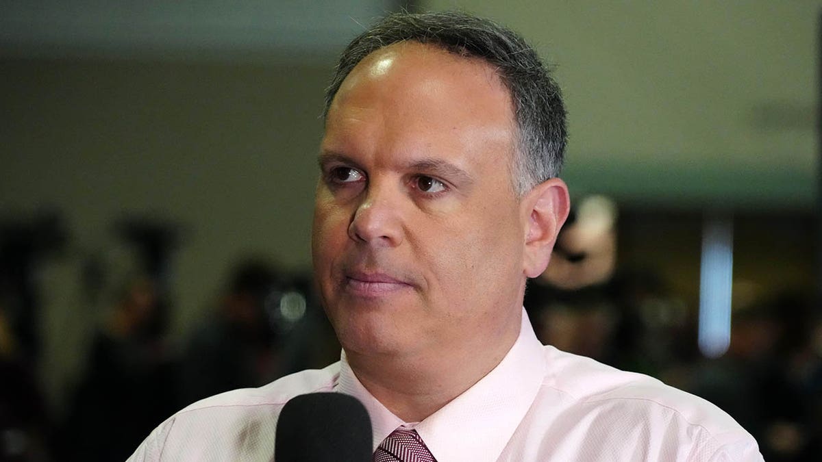 Mike Tannenbaum at the scouting combine