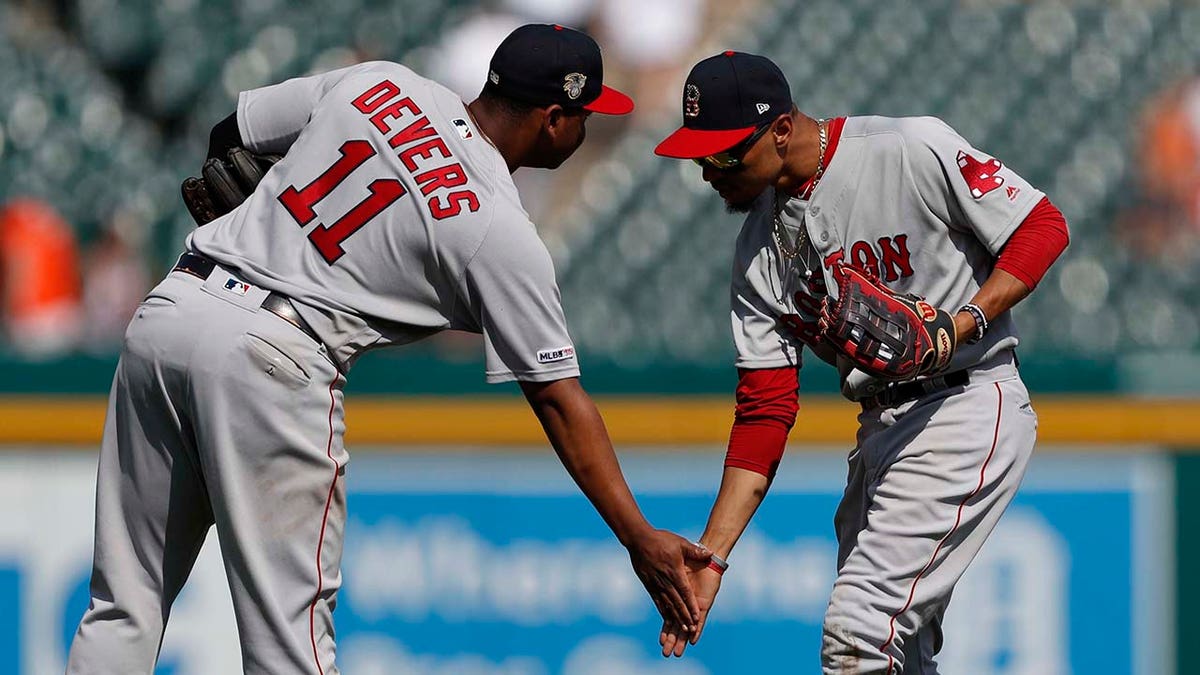 Rafael Devers and Mookie Betts celebrate