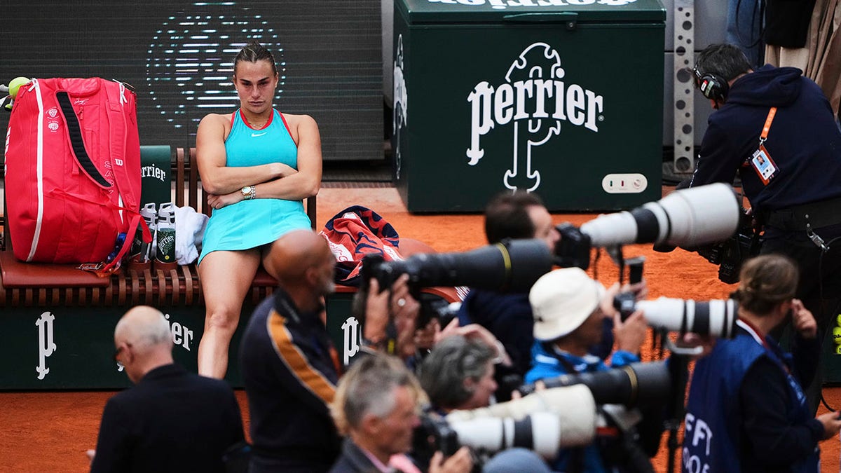 Aryna Sabalenka sits on the bench