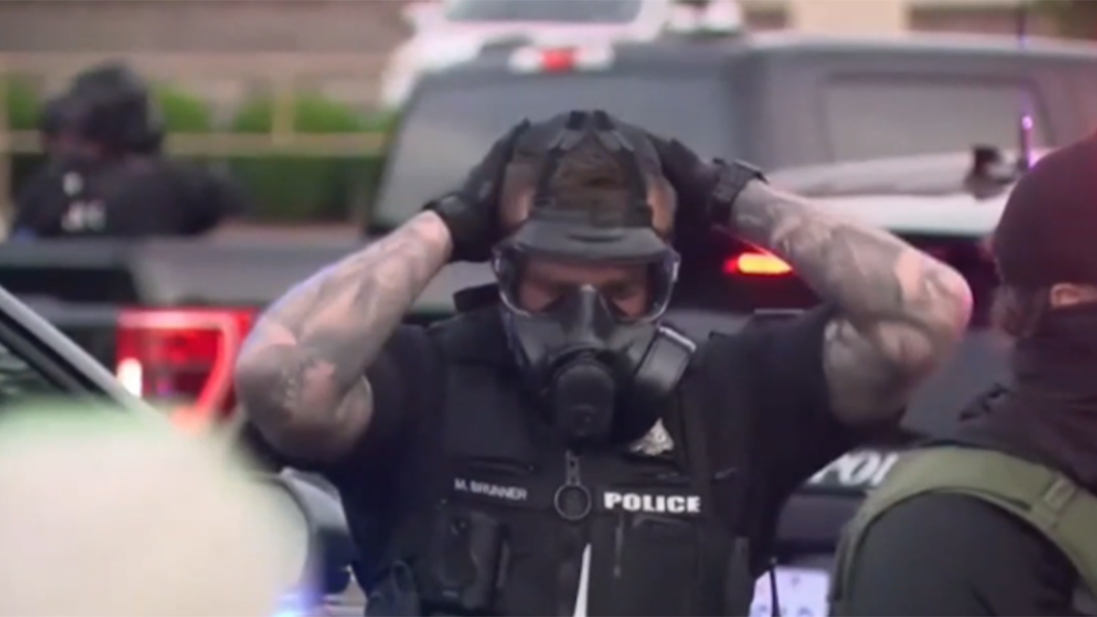 spokane police officer wears gas mask