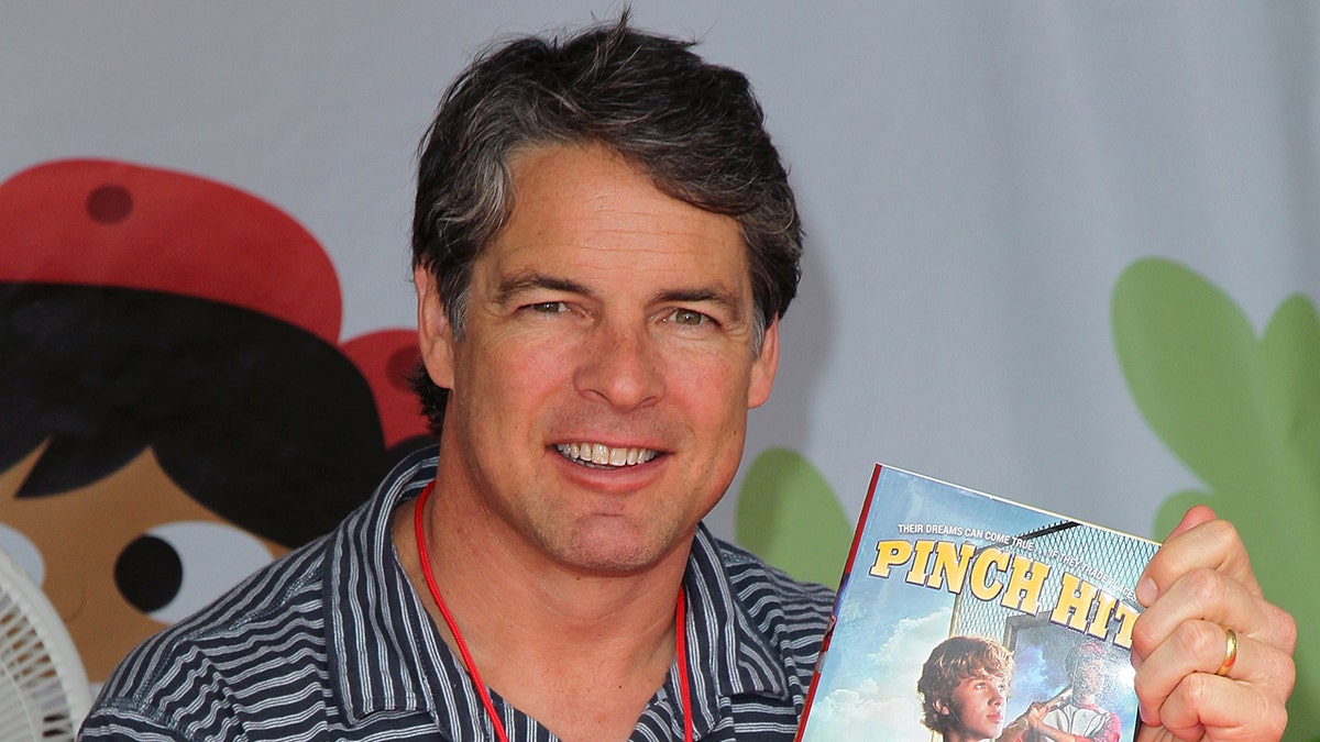 Tim Green poses with book