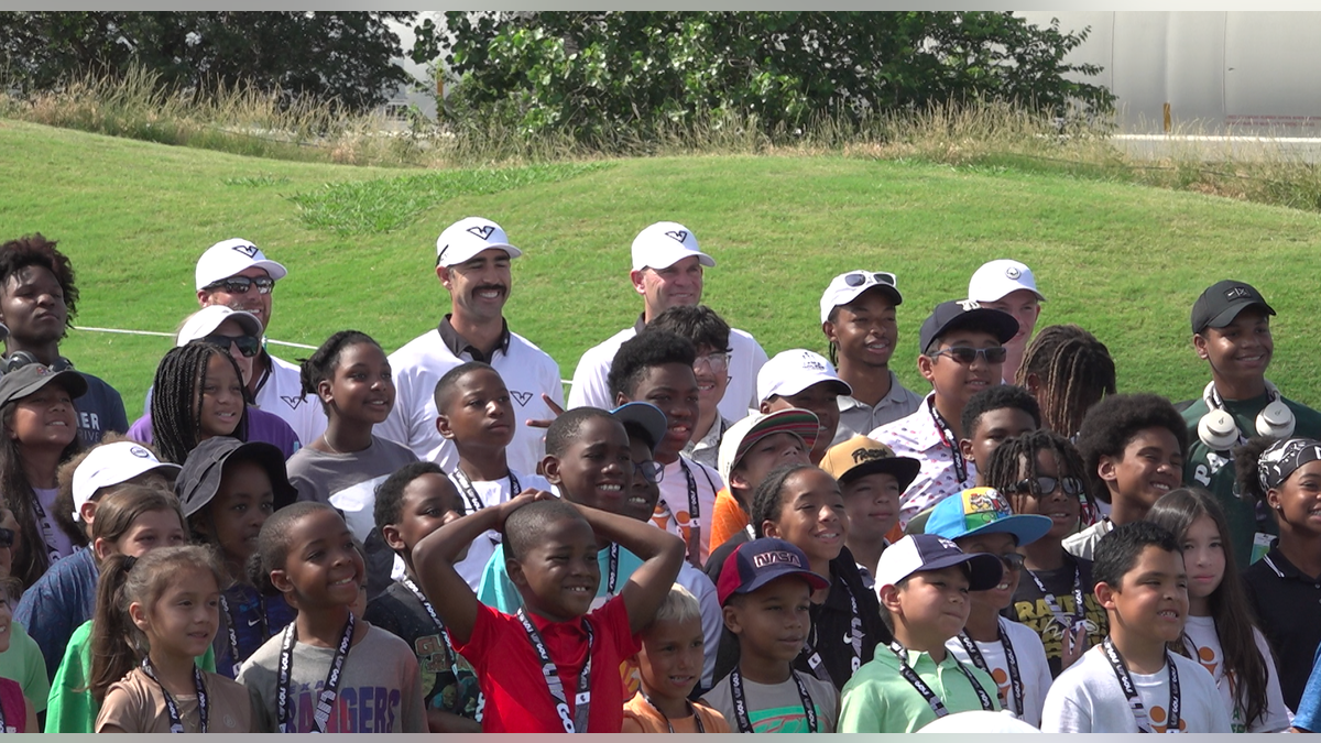 Kids from the greater DFW area pose for a picture with players from LIV Golf's HyFlyers GC.