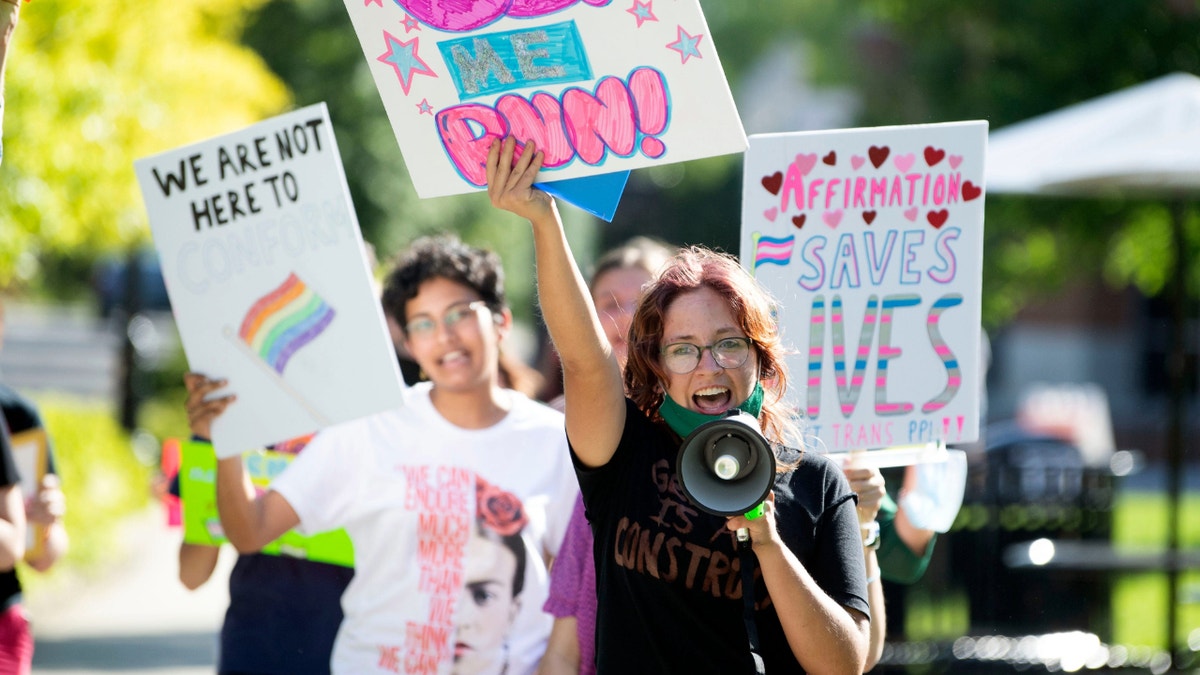 A student leads a group of demonstrators in Knoxville, Tennessee, in protest of the state’s 2022 transgender athlete ban. (Saul Young/Knoxville News-Sentinel /USA Today)