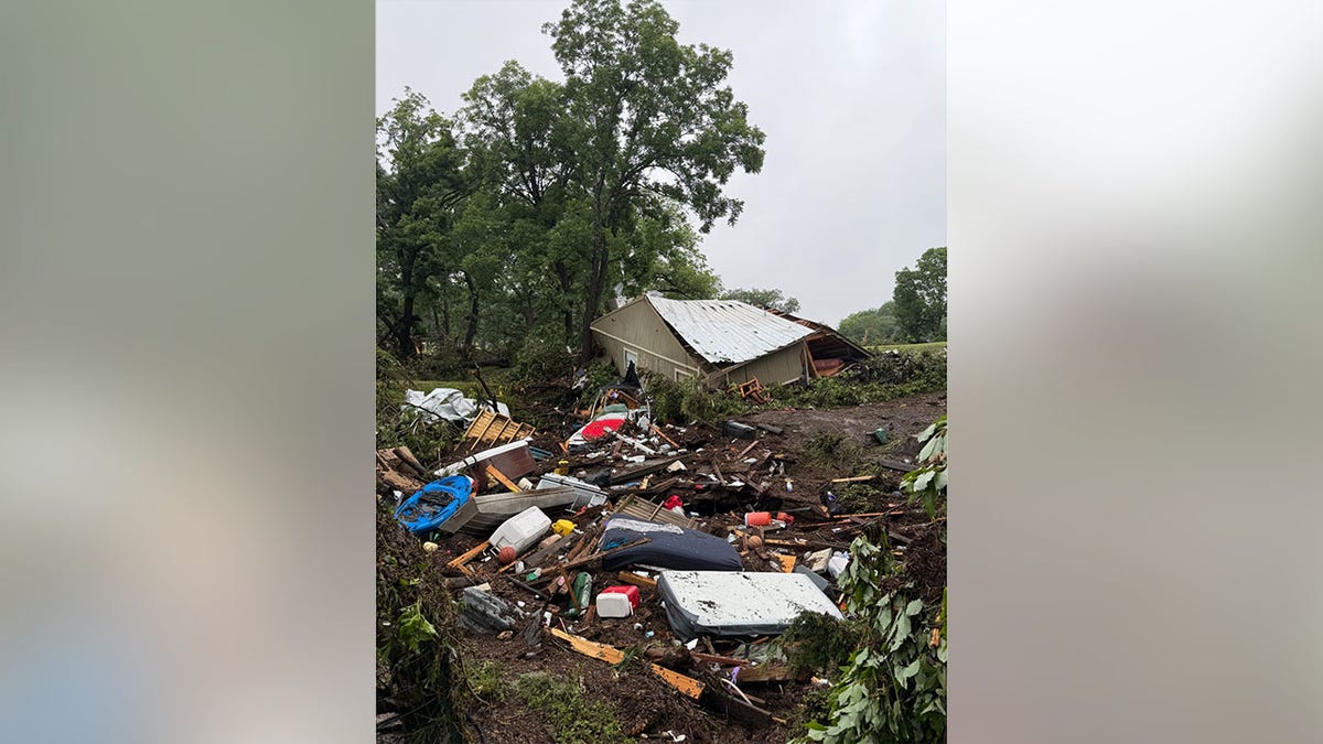A ruined building is seen behind a pile of wreckage following extreme flooding in Texas.