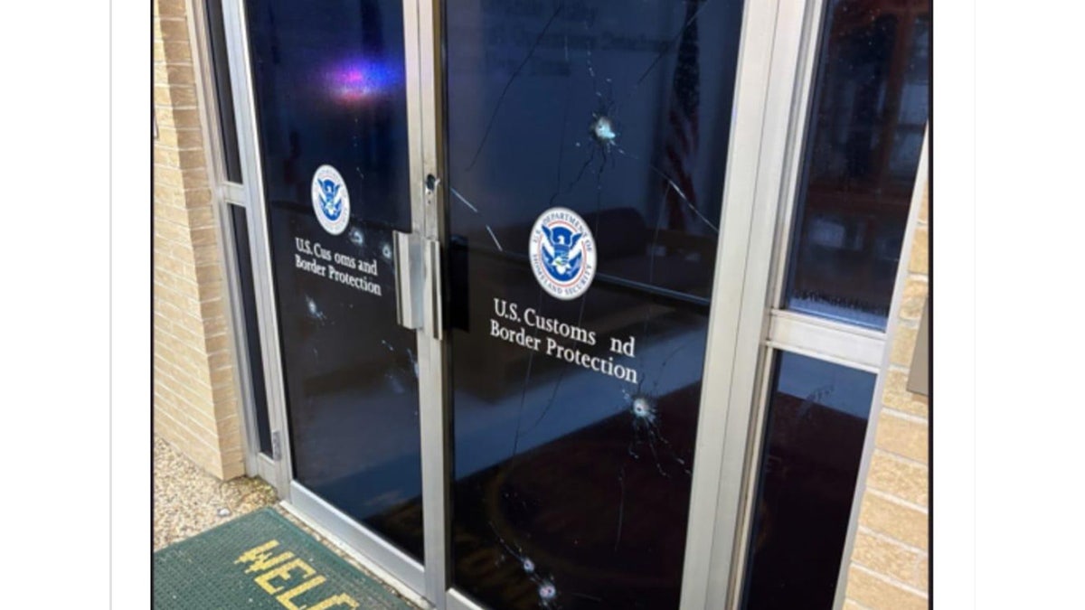 Border Patrol facility doors with bullet holes