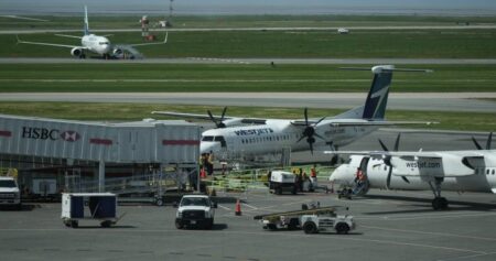 WestJet passengers evacuate on slides after engine fire at Vancouver airport