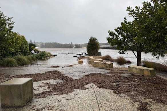 The waters of Burrill Lake inundate a picnic area after more than 220 millimetres of rain smashed nearby Ulladulla.