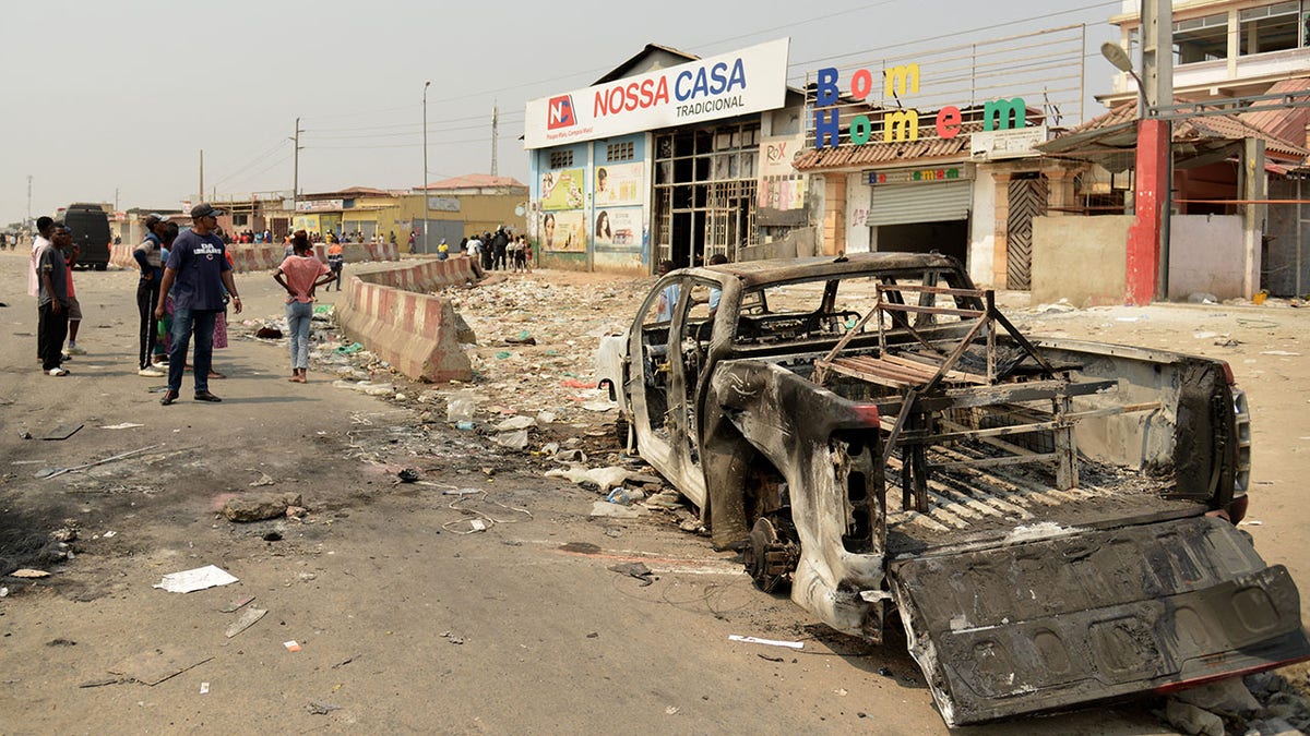 A burned vehicle in the street in Angola