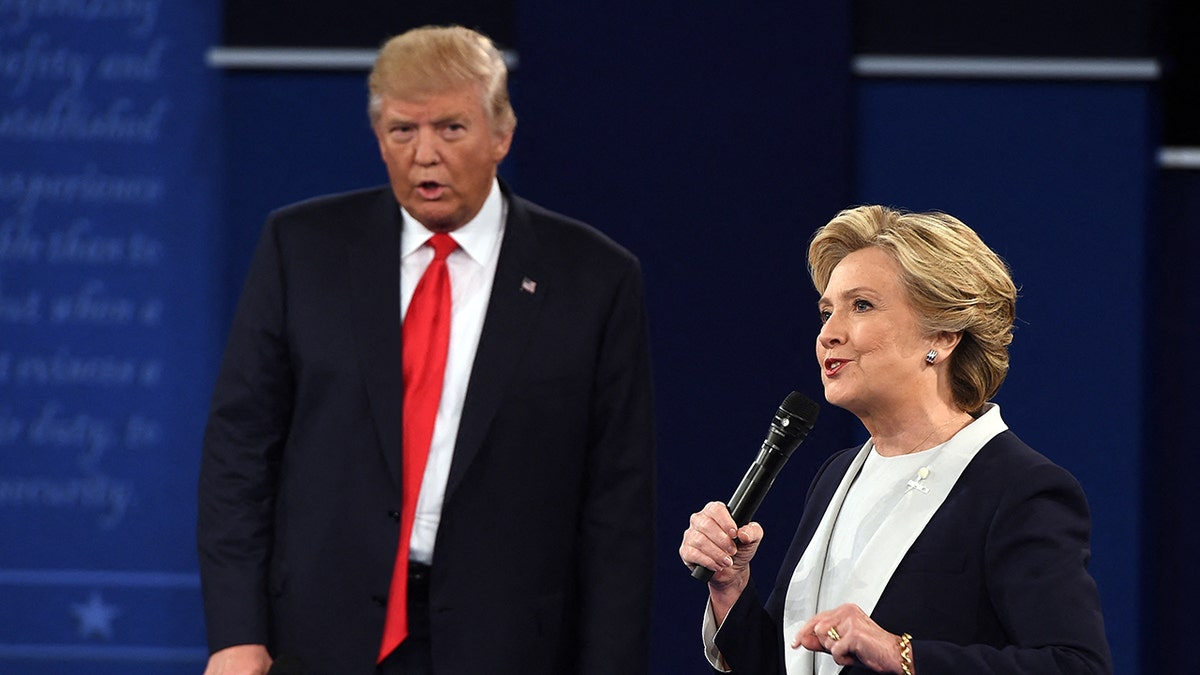 TOPSHOT - US Democratic presidential candidate Hillary Clinton and US Republican presidential candidate Donald Trump debate during the second presidential debate at Washington University in St. Louis, Missouri, on October 9, 2016. (Photo by Robyn Beck / AFP) (Photo by ROBYN BECK/AFP via Getty Images)