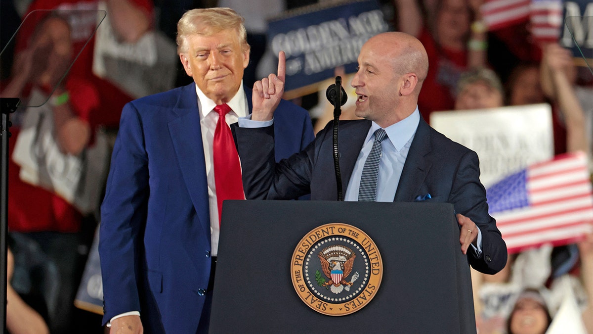 White House deputy chief of staff for policy and U.S. homeland security advisor Stephen Miller, right, speaks as President Donald Trump delivers a speech in Warren, Michigan, on April 29, 2025.