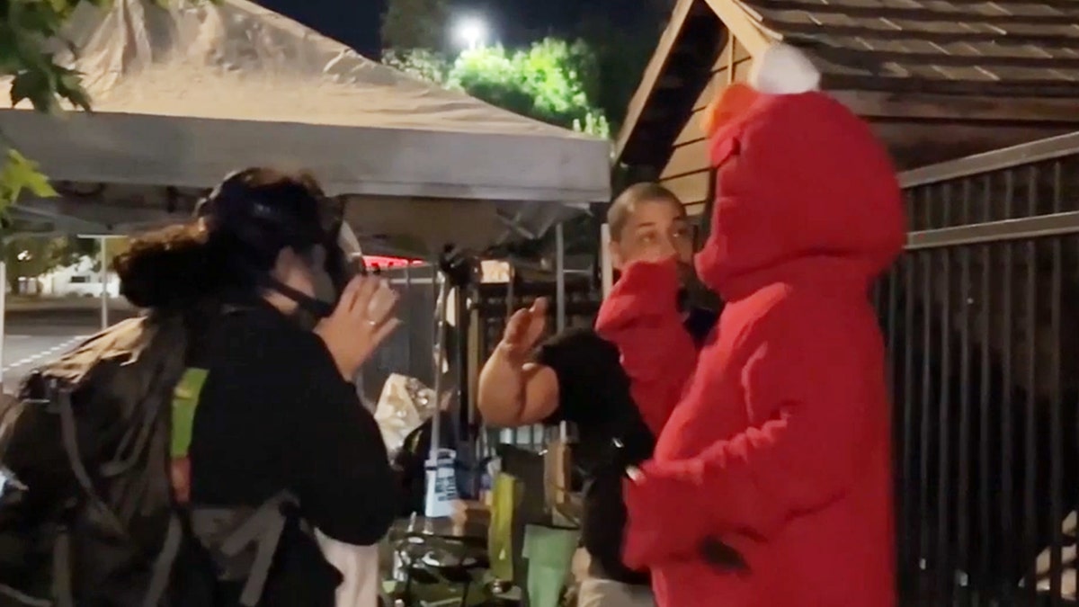 Elmo dances next to anti-ICE demonstrators