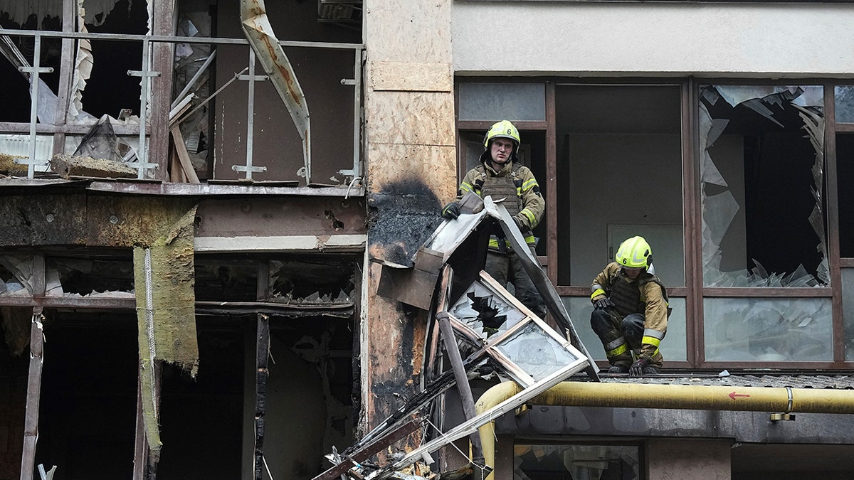 Firefighters work in destroyed building in Ukraine