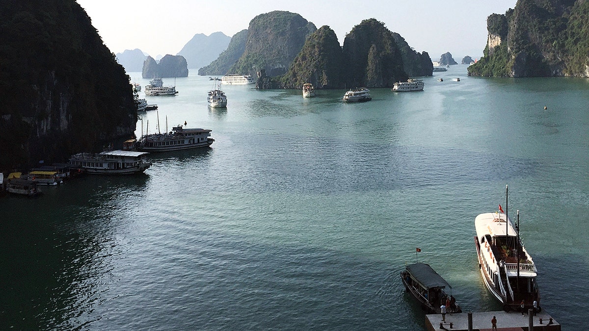 An overhead view of a bay with boats and mountains
