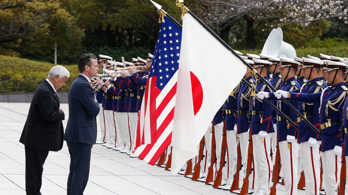 U.S. Defense Secretary Pete Hegseth and Japan’s Defense Minister Gen Nakatani inspect an honor guard during a formal welcome ceremony in Tokyo on March 30, 2025.