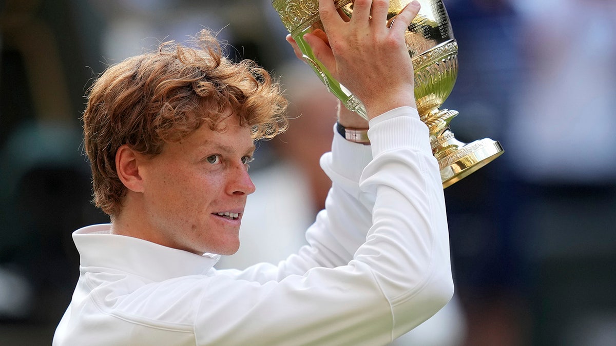 Jannik Sinner holds the trophy