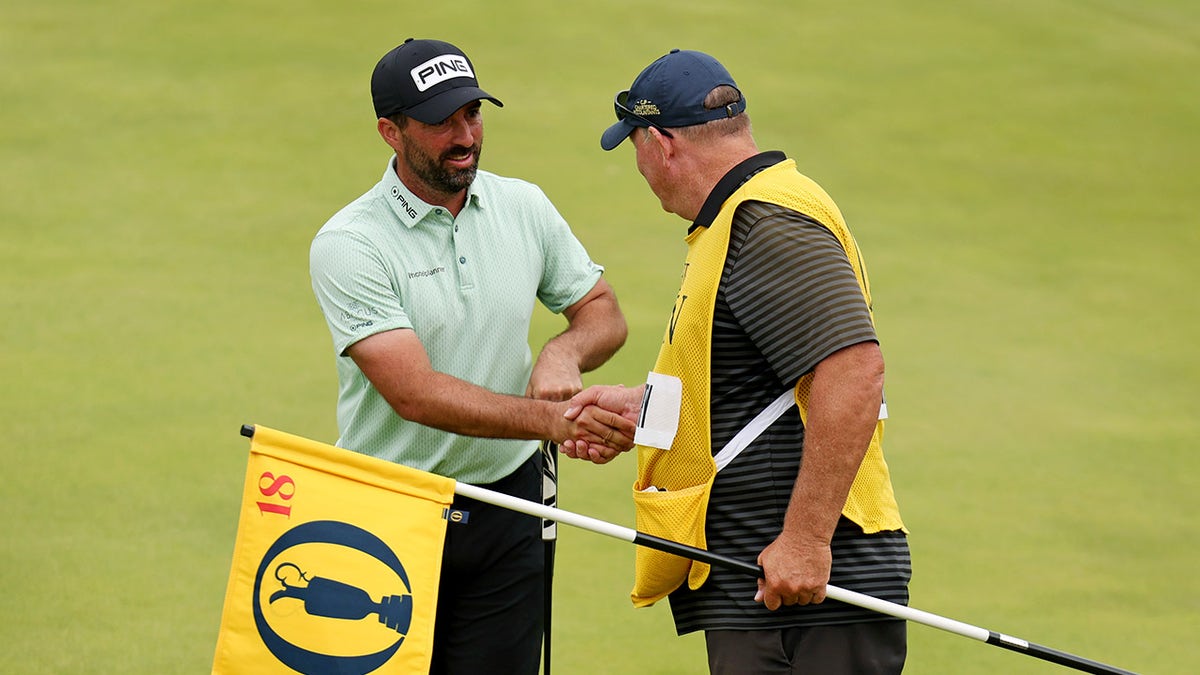 John Parry shakes hands with caddy