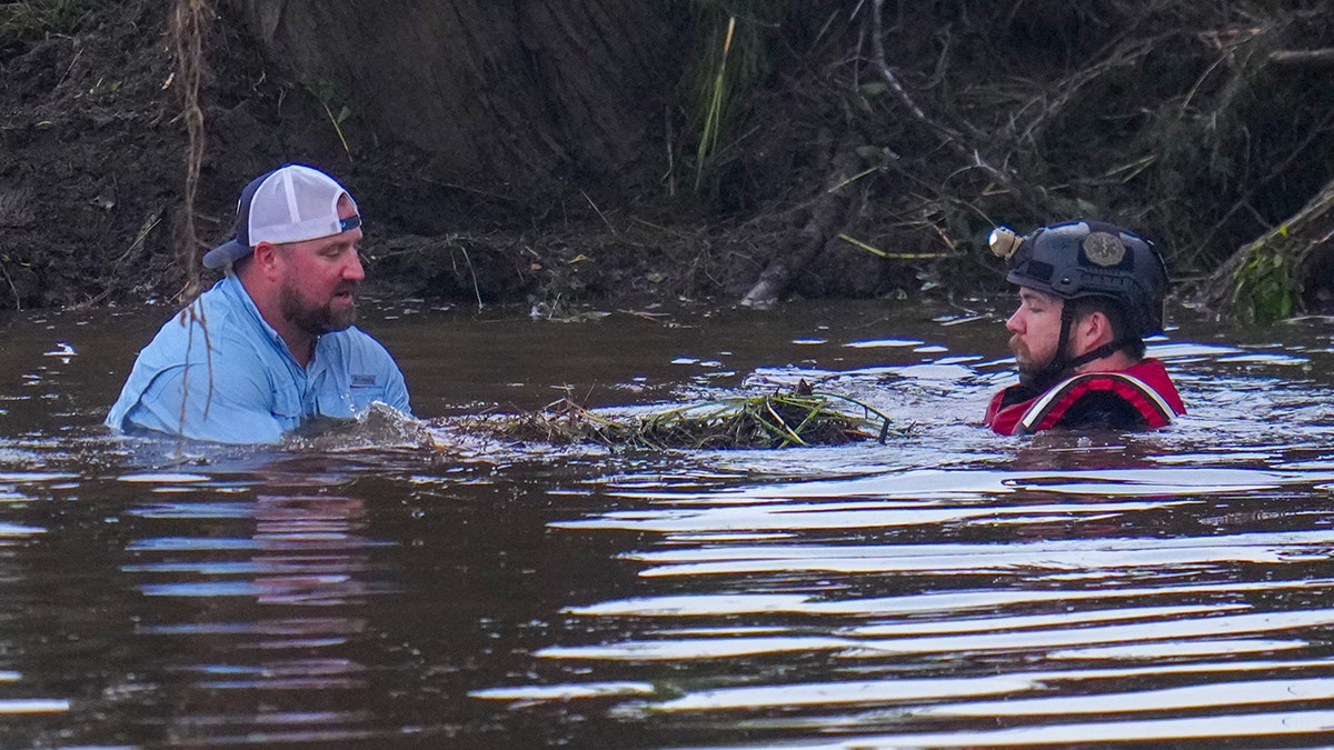 Emergency workers search through rubble to find missing people after flash flood.