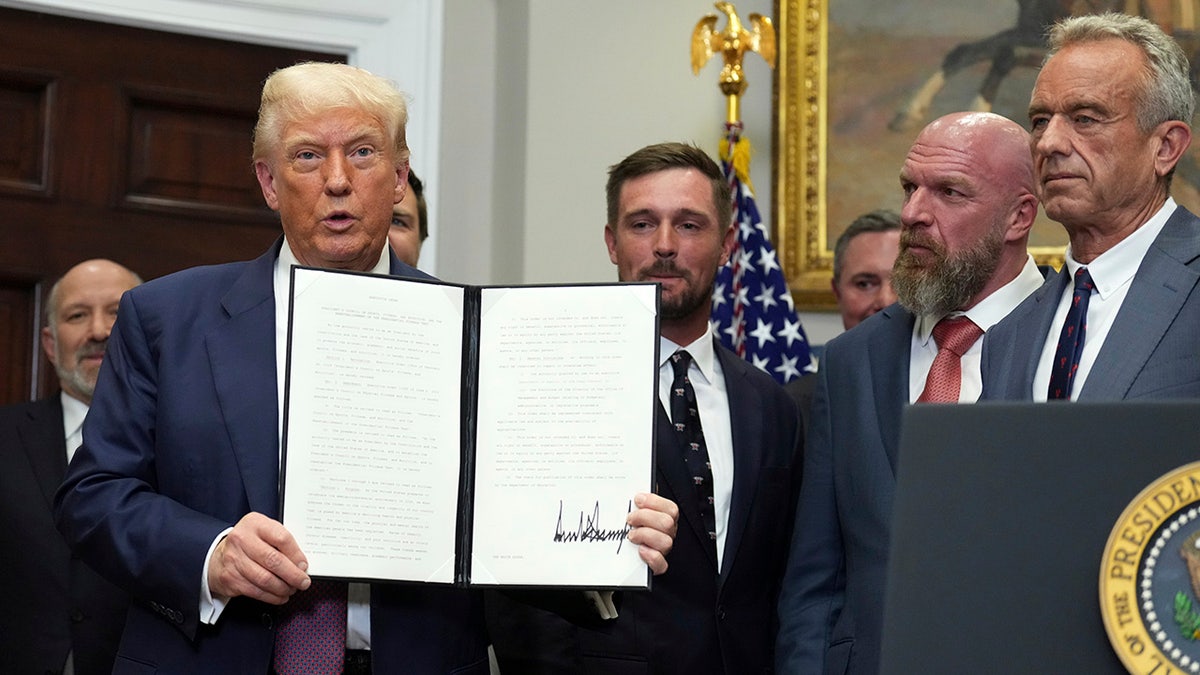 Trump with the executive order in July 2025.