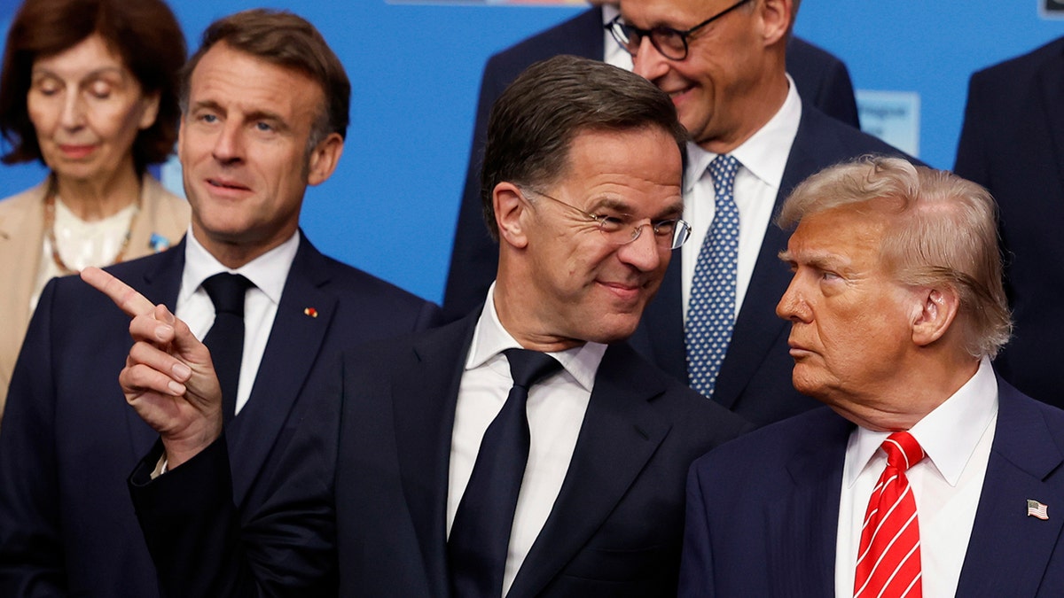 President Donald Trump, right, speaks with NATO Secretary General Mark Rutte during a group photo of NATO heads of state and government at the NATO summit in The Hague, Netherlands, Wednesday, June 25, 2025.