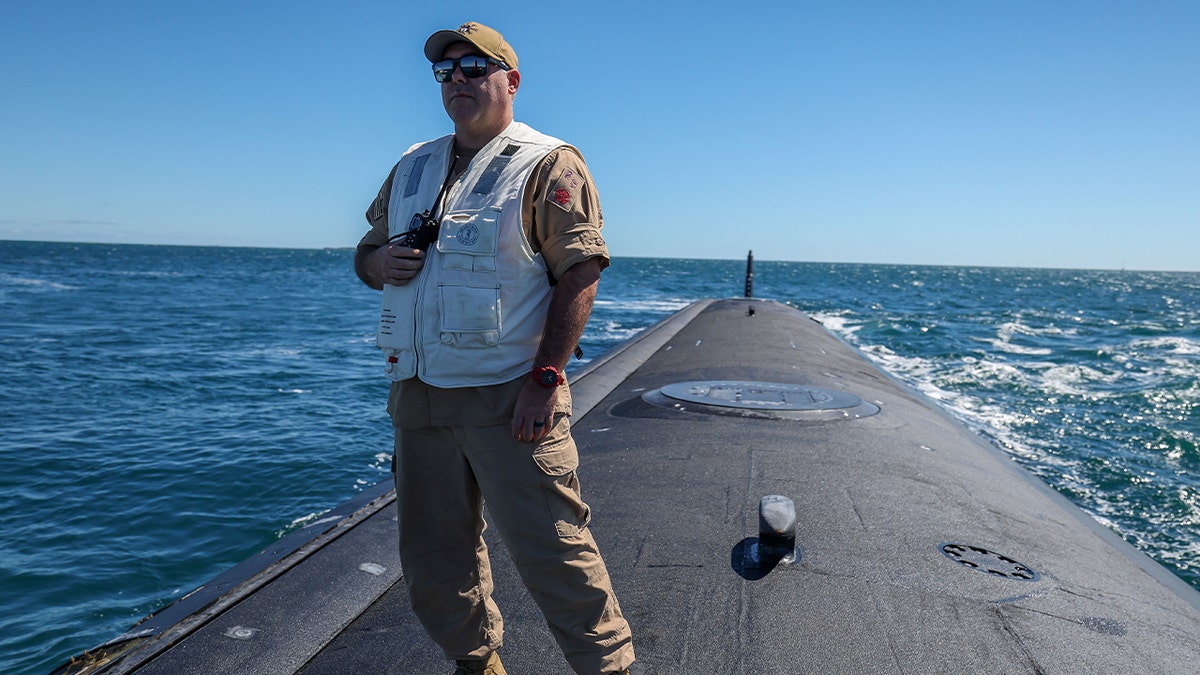 AT SEA, AUSTRALIA - MARCH 16: Master Chief Missile Technician Kevin Lewis, Minnesota Chief of the Boat stands on the stern of USS Minnesota (SSN-783) Virginia-class fast attack submarine in the waters off the West Australian coast on March 16, 2025 in at sea, West Australian coast. The submarine was on a port visit.