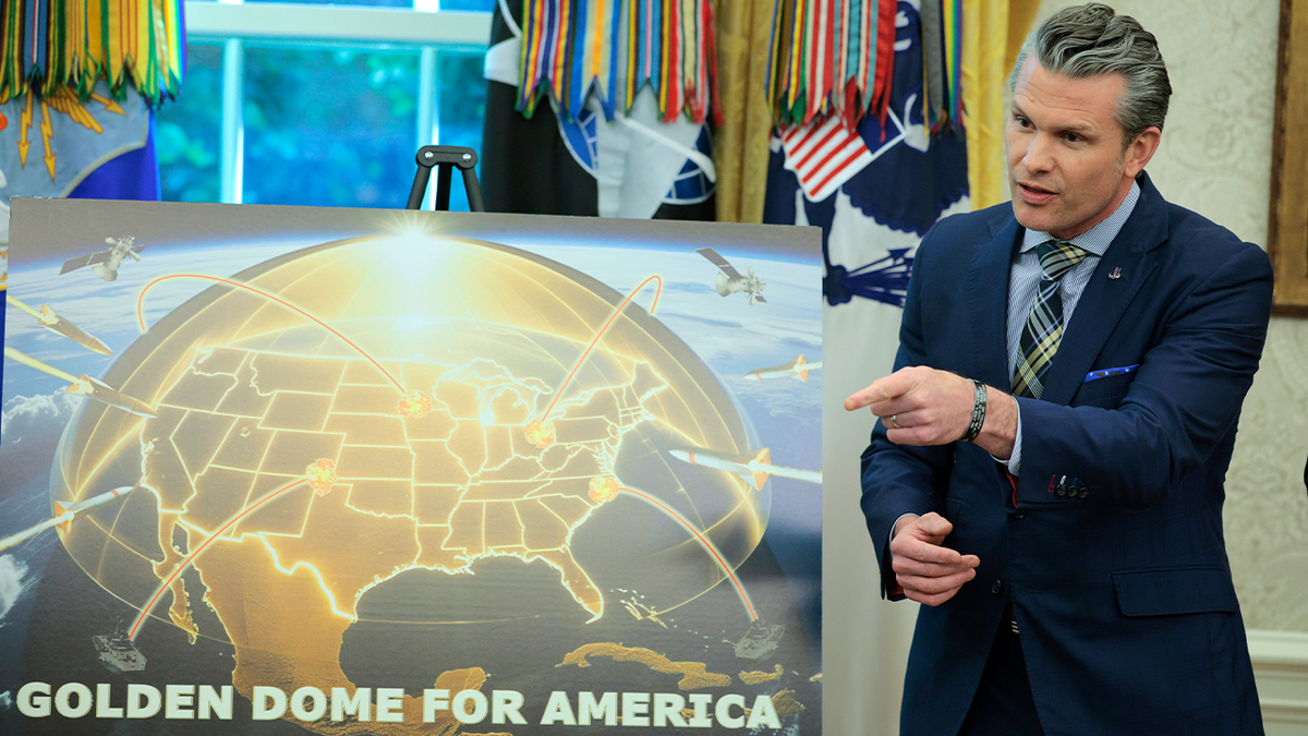 Hegseth with Golden Dome sign