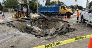 Sinkhole opens at busy Toronto intersection, leading to basement flooding