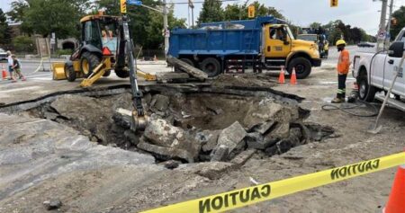 Sinkhole opens at busy Toronto intersection, leading to basement flooding