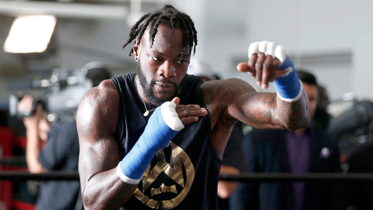 Deontay Wilder shadowboxes