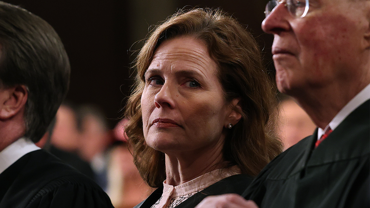 Justice Barrett pictured between two other SCOTUS justices