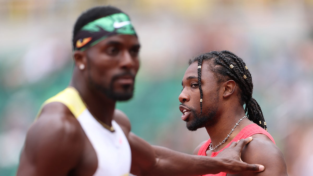 Kenny Bednarek pushing Noah Lyles