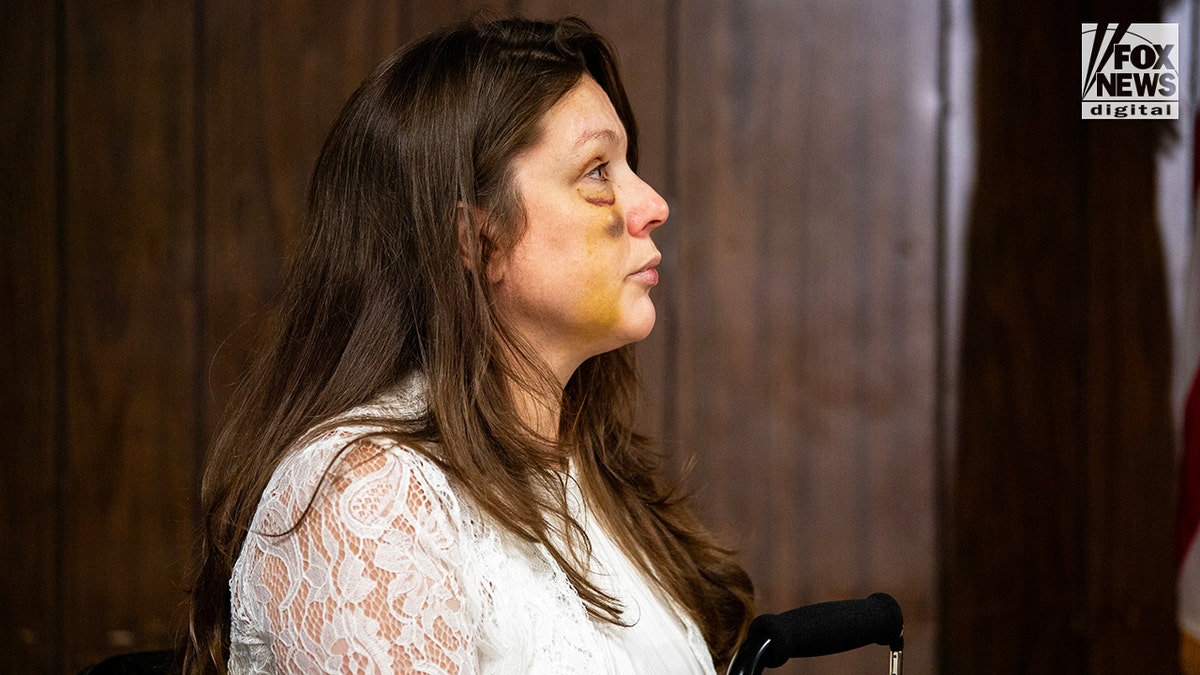 Holly, a victim in the viral July 26 brawl in Cincinnati, listens as Sen. Bernie Moreno speaks
