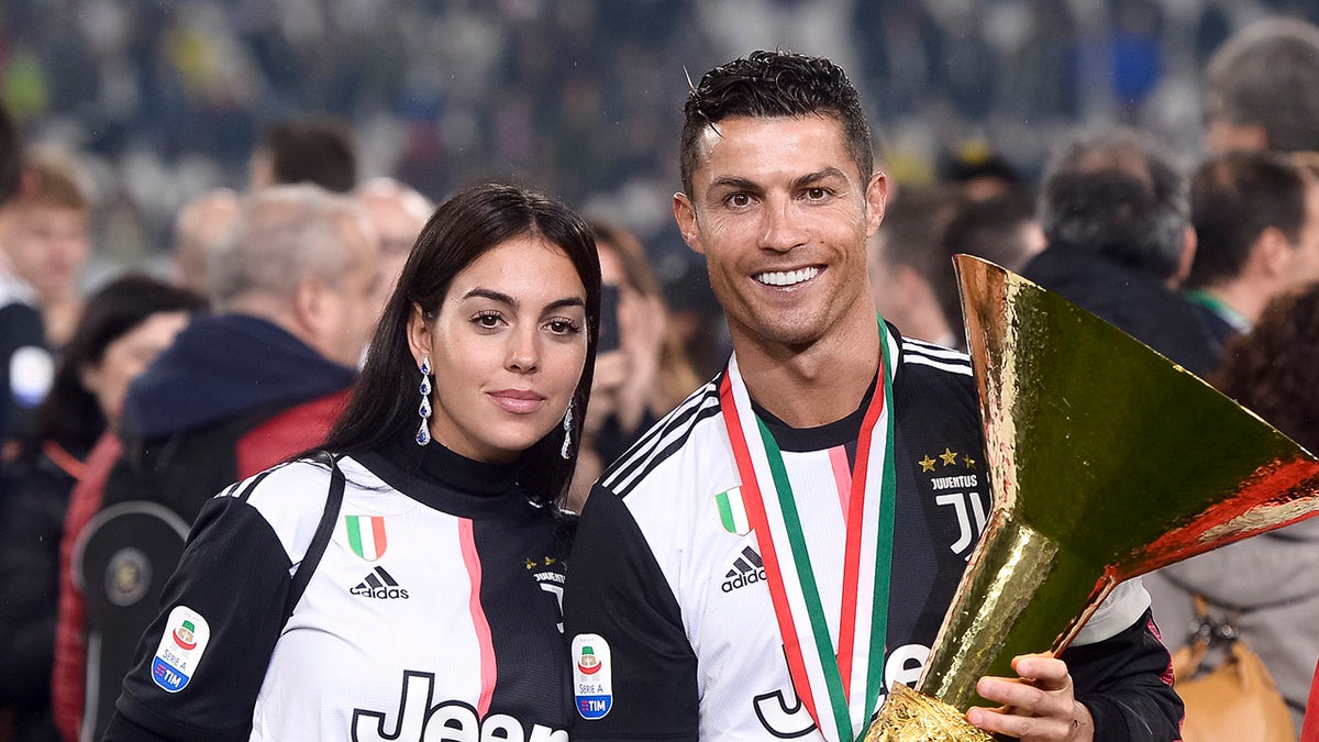 Cristiano Ronaldo and Georgina Rodriguez with trophy