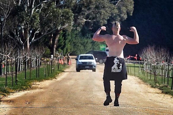 An attendee of the neo-Nazi gathering poses in a laneway on Saturday.