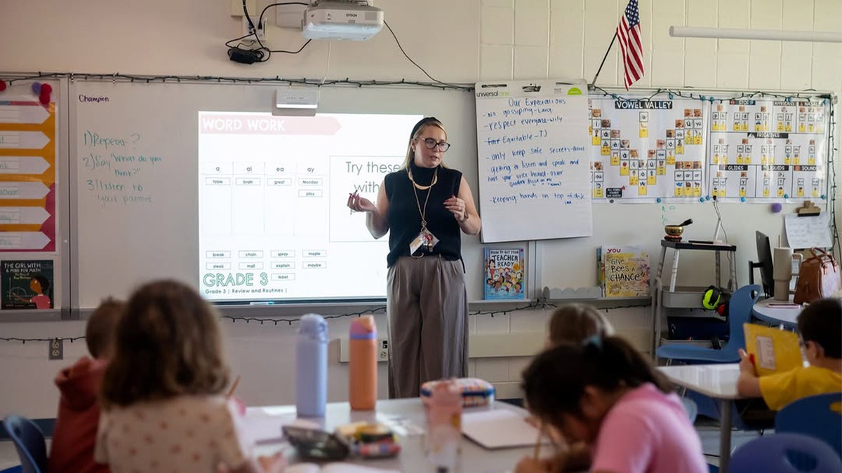 third grade teacher conducting lesson in classroom