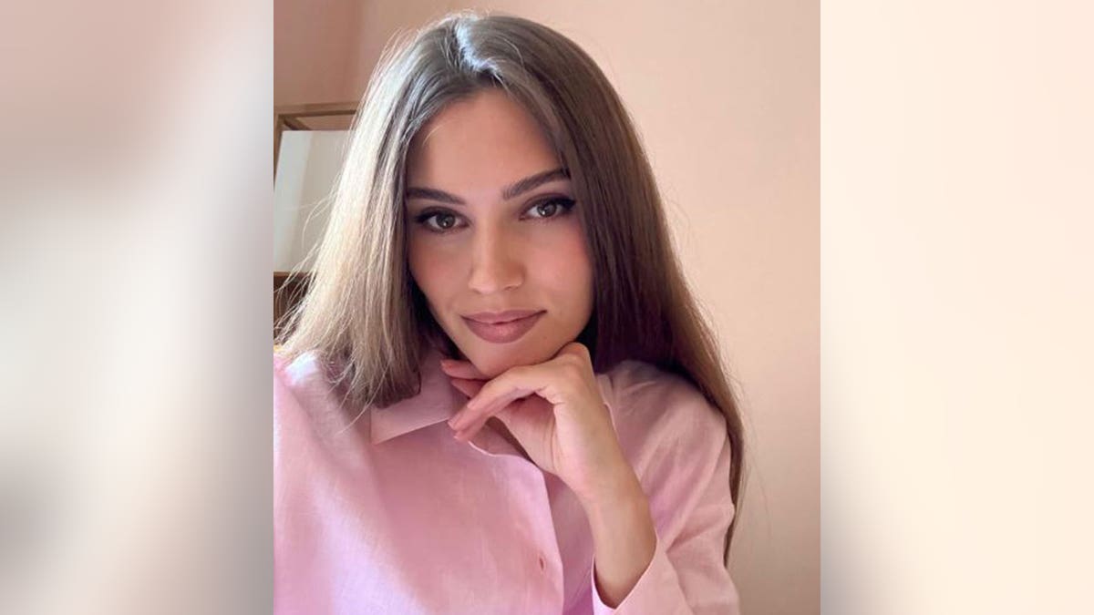 Kseniya Alexandrova posing for a photo in a pink outfit