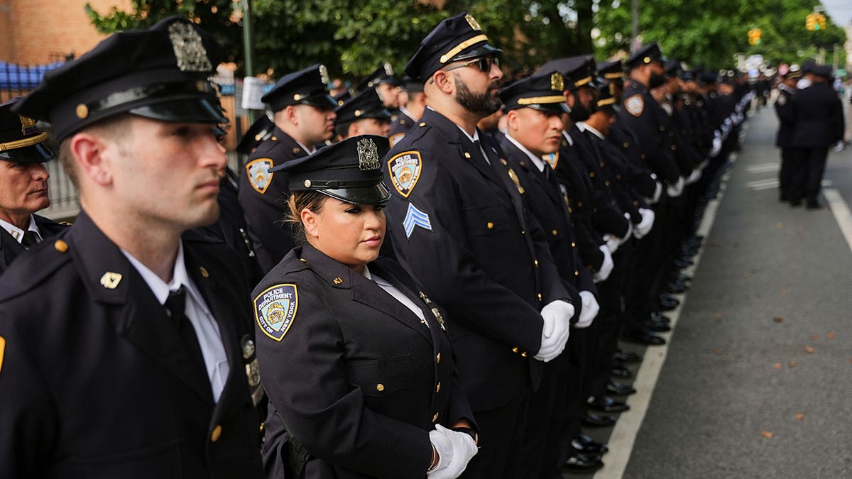 NYPD officers in dress uniform outside mosque during funeral