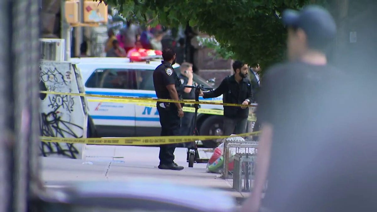 NYPD officers investigated Harlem sidewalk shooting scene