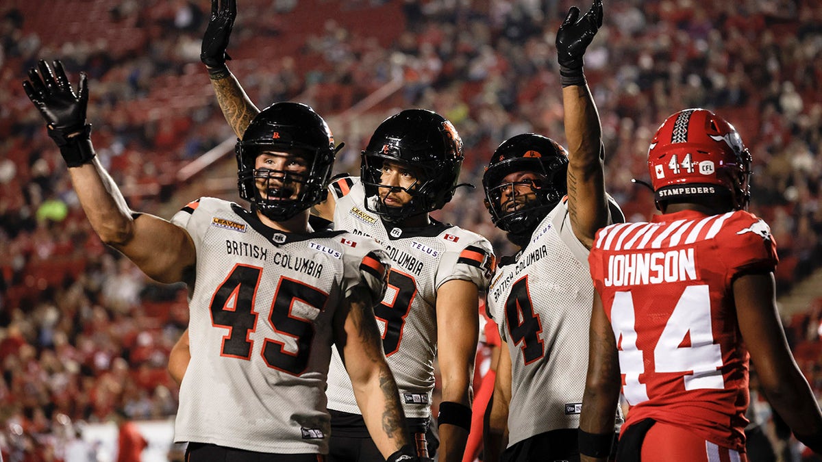 BC Lions players wave
