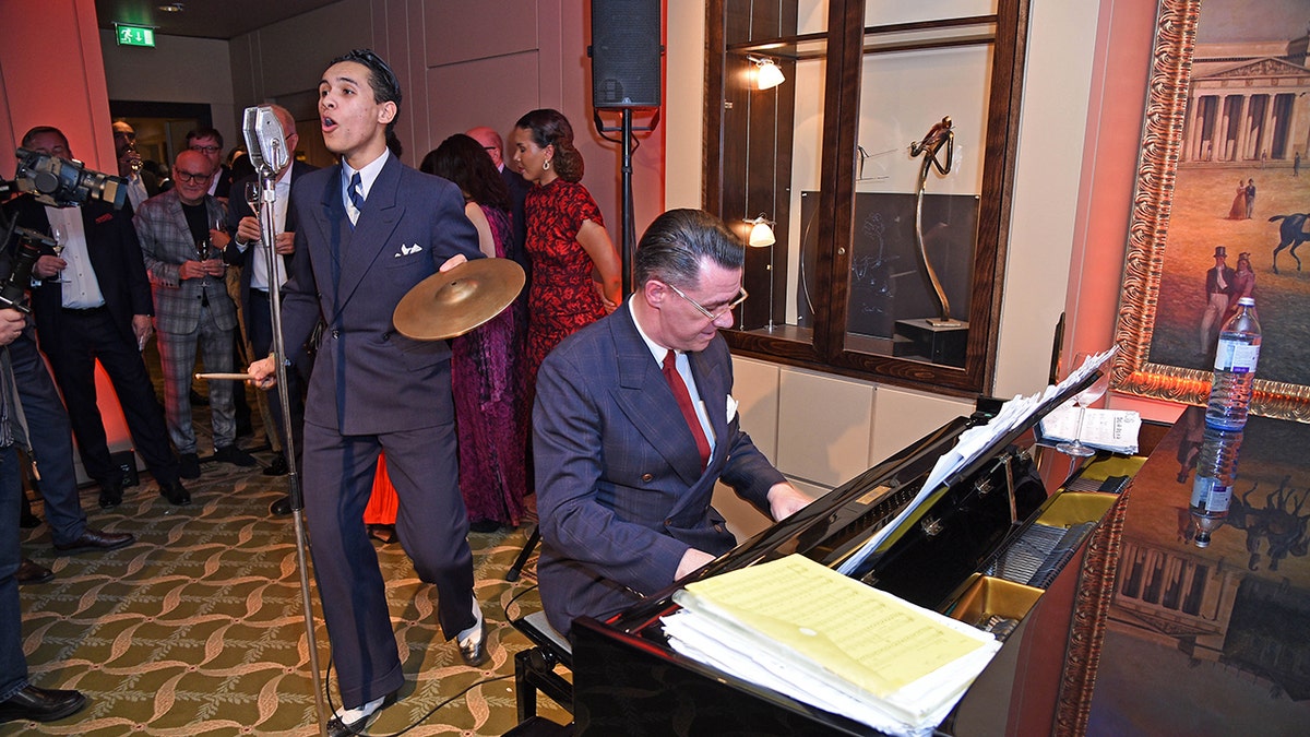 Swing musician David Hermlin performs with his band in Berlin in a 1930s-style suit.