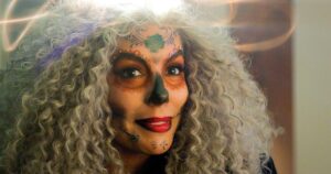 Eva Longoria Looks Unrecognizable in ‘Christmas Karma’ Trailer With Gray Hair and Painted Face