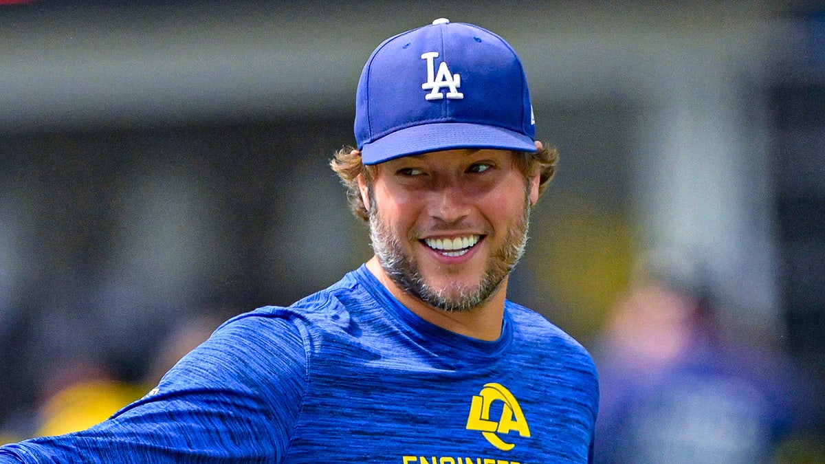 Matthew Stafford points on field