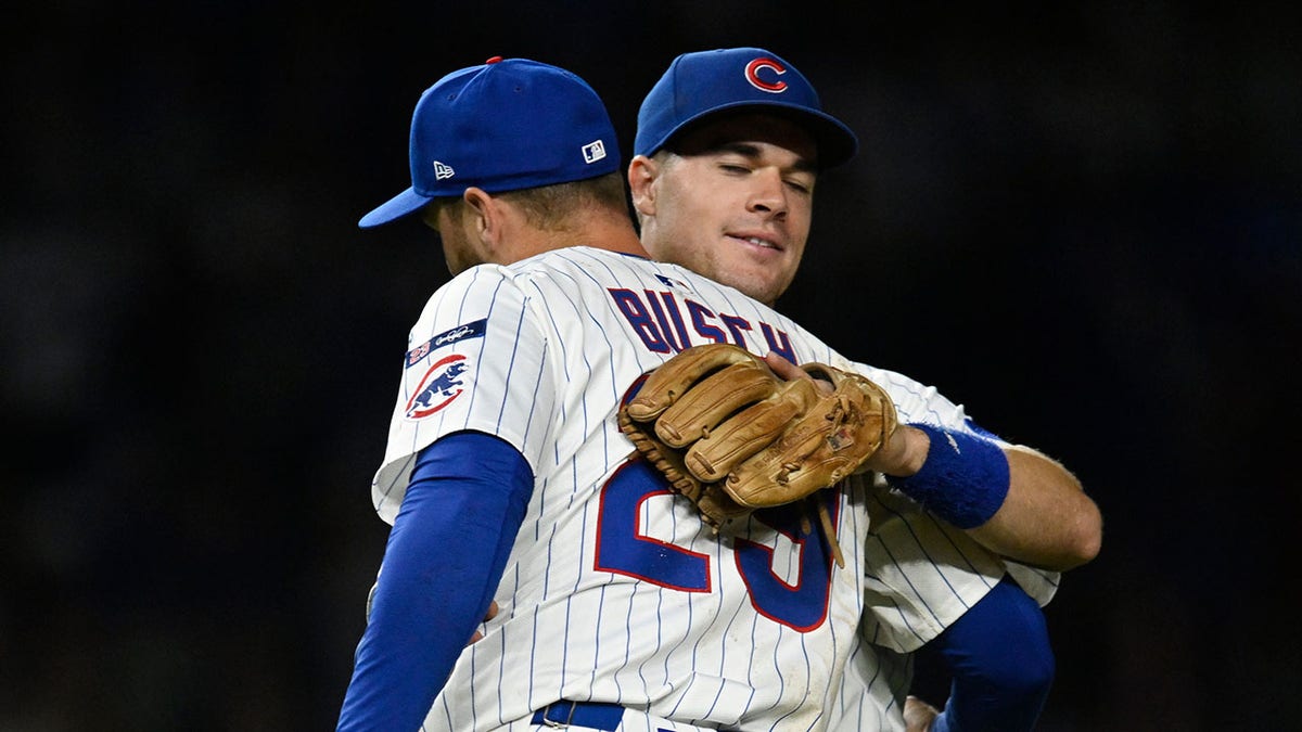 Matt Shaw hugs Michael Busch