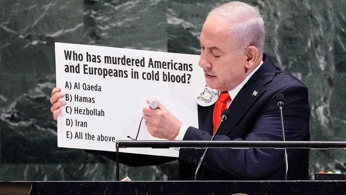 Israeli Prime Minister Benjamin Netanyahu holds up a poster during a speech at the United Nations General Assembly